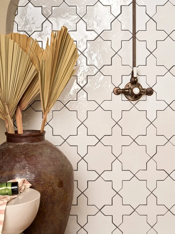 cream pattern tiles with bronze bathroom fitings