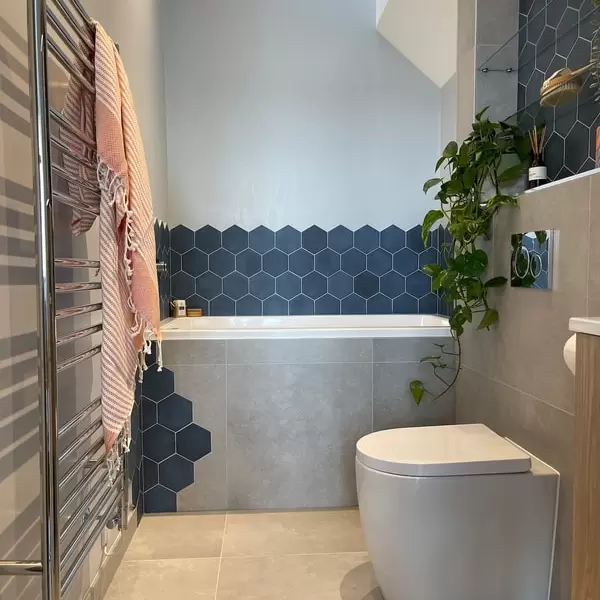 bathroom design and supplied by interiora, featuring grey floor tiles and blue hexagon wall tiles