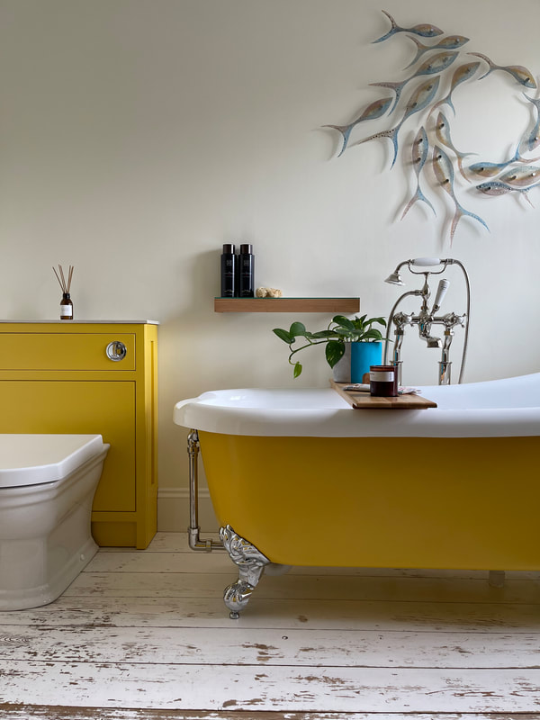 yellow free standing bath with matching cistern unit