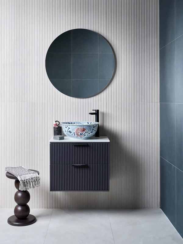 wall hung vanity unit on vertical textured wall tiles